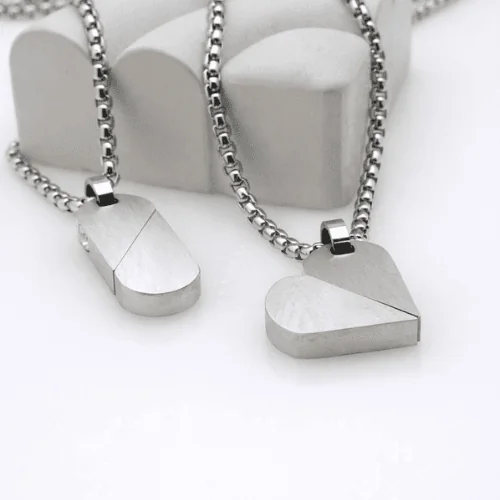 Два кулони-трансформери HEART-TAG у складеному та розкладеному вигляді поруч.